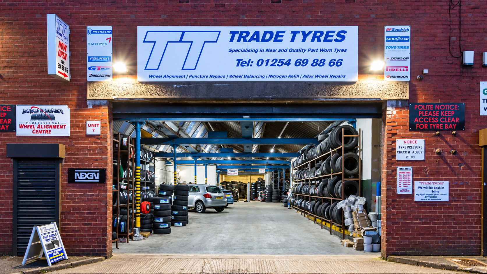 Trade Tyres unit on Carluke Street Trade Tyres unit entrance on Carluke Street, Blackburn, with racks of tyres inside