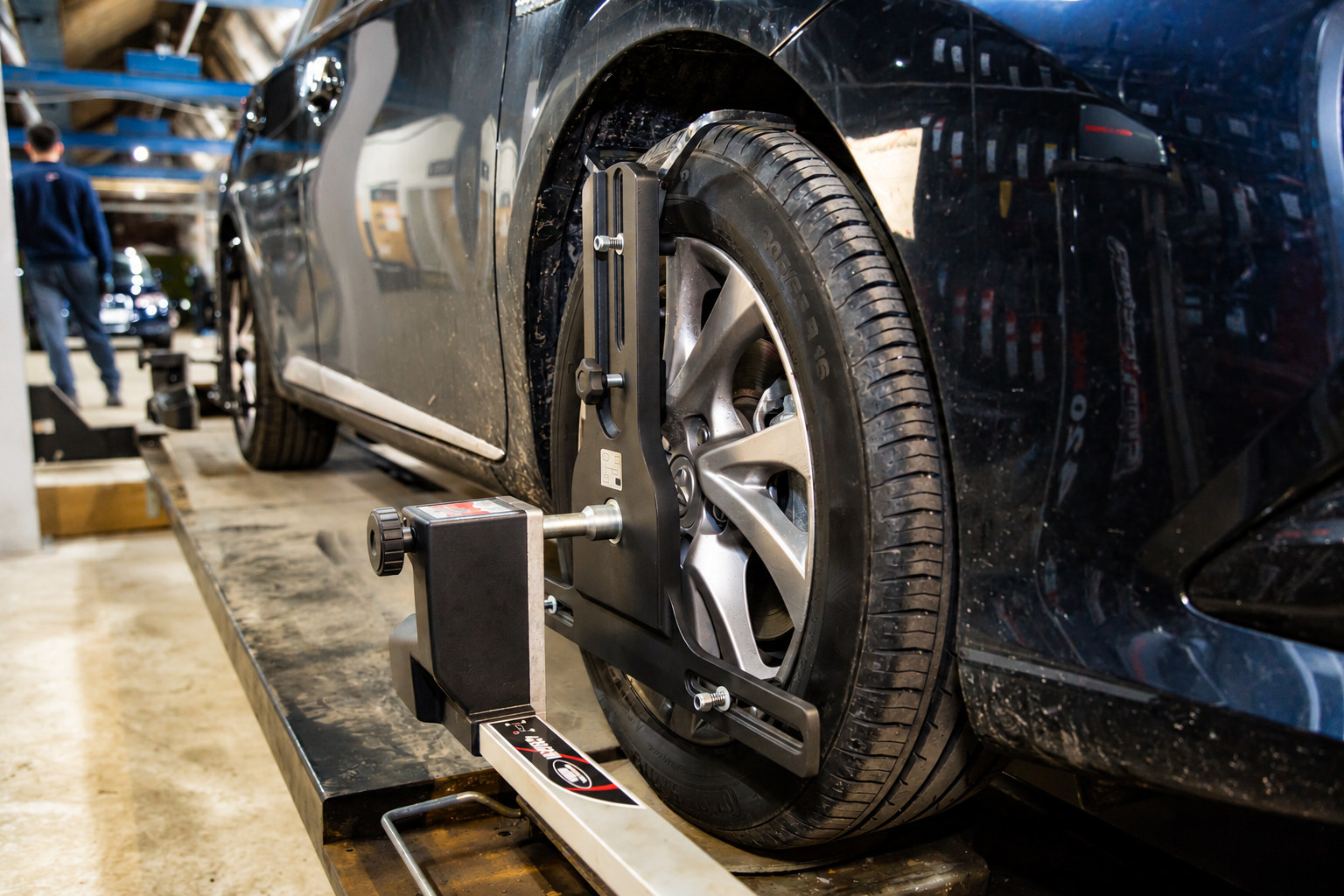 3D wheel alignment in the workshop 3D wheel alignment sensor clamped to a car wheel in the workshop